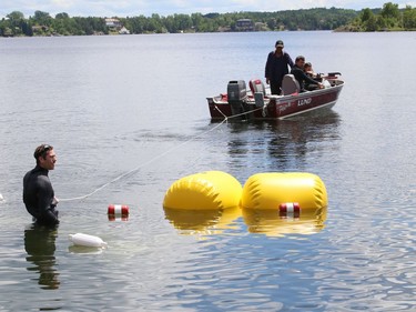 Flotation devices are used during the transportation of concrete blocks to the location where an inflatable water park will be located on Ramsey Lake on Wednesday. Splash N Go Adventure Parks Limited will open the water park in early July.