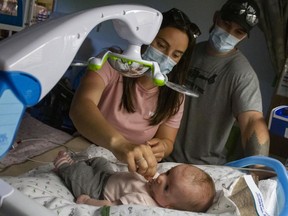 Little Tessa with her parents, Victoria Niven and Trent Mallette, who are both firefighters with the Greater Sudbury Fire Service. Annie Duncan photo