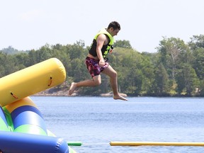Dean Gagne, 16, jumps off an inflatable at the Splash N Go Adventure Parks Limited on Ramsey Lake in Sudbury, Ont. on Monday July 18, 2022. John Lappa/Sudbury Star/Postmedia Network