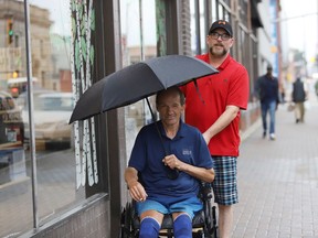 Jake Little (back) and Noel Prudhomme make their way downtown as rain begins to come down in Sudbury, Ont. on Wednesday July 20, 2022. Environment Canada said Greater Sudbury can expect a mix of sun and cloud in the afternoon with a high of 26 C and a humidex of 31 C Thursday. John Lappa/Sudbury Star/Postmedia Network