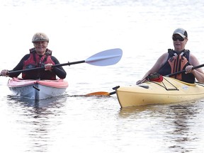 Jane Davey, left, and Barb Jeffrey go kayaking on Ramsey Lake in Sudbury, Ont. on Monday July 25, 2022. John Lappa/Sudbury Star/Postmedia Network