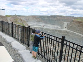 Patrick Boudreau, 4, and Bryce Wemyss, 5, admire the view from the newly opened Hollinger Open Pit lookout on Saturday. Moving forward, the lookout will be open to the public daily from 8 a.m. to 8 p.m. between June 1st to Oct. 1st. The site has 10 parking spots.  Newmont Porcupine security will ensure that all public visitors are removed from the lookout close to and during blast times. Access to the lookout is off Brunette Road, just south of Shania Twain Way.

NICOLE STOFFMAN/The Daily Press