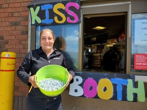 Mel Walsh, Assistant Manager of the local Tim Hortons franchise holds a bucket of Hershey Kisses that were on sale to raise money for camp day.