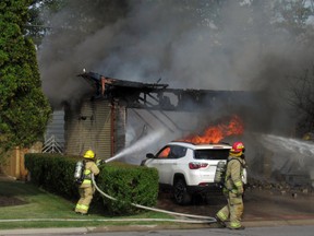 Kingston Fire and Rescue firefighters respond to a house fire on Auden Park Drive in Kingston on Monday, Aug. 1, 2022.