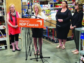 NDP Leader Rachel Notley, joined by Leduc Food Bank Executive Director Gert Reynar, Alberta Food Banks CEO Arianna Scott, and St. Albert MLA Marie Renaud, calls on the UCP to address the rising cost of living and increased reliance on services such as food banks, at the Leduc Food Bank, July 28. (Dillon Giancola)
