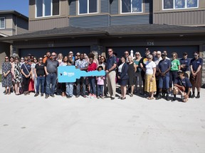 Habitat for Humanity Edmotnton celebrates the opening of a duplex in Spruce Grove with local dignitaries and the families who will occupy the homes. The project represents the 800th build for the organization. Submitted Photo.