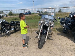 Six-year-old Ayden looks at his favourite motorcycle Saturday during the North Star Guardian poker run and barbecue held at the West Ferris Royal Canadian Legion Branch 599 Saturday.