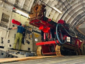 Loading crews from 8 Wing Trenton are pictured in the cargo bay of a C-17 Globemaster aircraft loading a special mining excavation system for delivery Sunday to the Dominican Republic to bore a rescue tunnel to save two miners trapped underground in a copper and zinc mine for more than a week. DND PHOTO