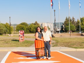 Judy Ducharme and Dave Maltipi standing on the new crosswalk at Treaty 8 Memorial.