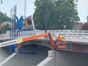 Work continues on the Third Street Bridge to install pedestrian railings. Municipal officials expect the bridge will reopen in early September. Ellwood Shreve/Postmedia
