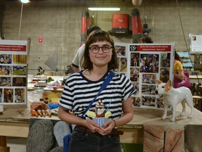 Sachi Belle, a student in Off the Wall Artists Alliance's prop-making course, shows off one of the food props – an ice cream sundae – she made this week.  Belle is one of dozens of students who benefitted from a nearly $40,000 provincial grant that helped Off the Wall continue operating during and recover from the COVID-19 pandemic.  Galen Simmons/The Beacon Herald/Postmedia Network