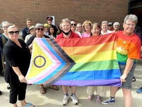 Acting Mayor Jamie McGrail (left) is joined in holding the Pride flag by Robert James Whittington and Marianne Willson during a flag-raising ceremony at the Civic Centre in Chatham on Monday to launch Pride week in Chatham-Kent. Submitted