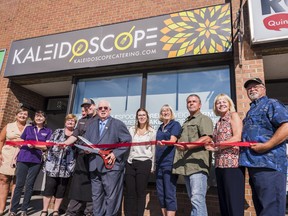 Quinte West Mayor Jim Harrison cuts the ceremonial red ribbon alongside members of city council and local business leaders as they welcome Kaleidoscope Catering to the community on Friday. ALEX FILIPE