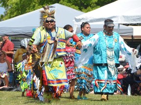 Head dancers Bill Mandawoub and Denise Waukey lead a dance during the Neyaashiinigmiing 36th Annual Traditional Pow Wow at Cape Croker on Saturday, August 20, 2022.