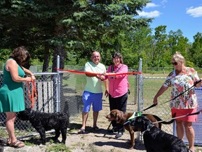 Kevin Legate and Mayor Janice Jackson prepare to cut the ribbon to open the Sauble Beach Dog Park, next to the Sauble Beach Community Centre, on August 12. On the left is Karen Burtynski, on the right, Becky Knight.
(SHell Partington