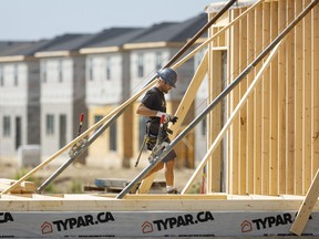 Jamie Daugharty of Willow Bridge Construction works on framing a new house near Wharncliffe Road South in London. Mike Hensen/Postmedia