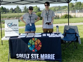 City of Sault Ste. Marie summer students Avery Marsh and Noah Edwards man a booth at the Summer Moon Festival, offering area residents a chance to update their voter information and engage them in the upcoming municipal election.   PHOTO SUPPLIED.