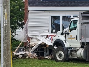 Emergency services responded to a dump truck that collided into a house Friday morning at the corner of Nipissing and Jane Streets.