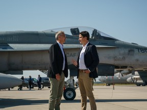 Canada's Prime Minister Justin Trudeau speaks with NATO Secretary General Jens Stoltenberg near a Canadian Forces CF-18 Hornet fighter aircraft during their visit to CFB Cold Lake in Cold Lake Friday.   Adam Scotti/Prime Minister's Office/Handout