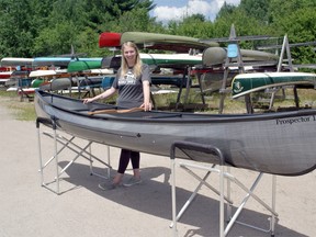 Jillian Conrad, production manager at Swift Canoe and Kayak with one of the many boats the company makes at the South River Factory.