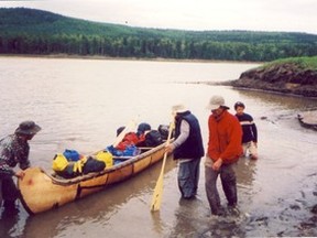 Although this photograph is not of the intrepid Lakehead University Sea to Sea project crew, nor its canoe, nor Bella Coola and The Rock, it is significant. The late Herb Setz, Sr. took the photo in 2003 of author and crew chief Robert Twigger (red jacket), and crew, guiding 21-foot Dragonfly on shore of Peace River at Peace River town. They, too, had the audacity to replicate the paddle strokes of Sir Alexander Mackenzie 1792-1793 expedition across Canada to Pacific Ocean. Dragonfly may be seen at Peace River Museum, Archives and Mackenzie centre.