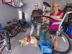 A.J. McCallum and his mom Heather McCallum, along with Leo, A.J.'s service dog, are pictured with just some of the bikes they are repairing and donating to migrant workers in SouthWestern Ontario. Mike Hensen/Postmedia