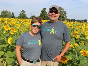 Shannon Armstrong and Brian Schoonjans stand next to sunflowers at the family farm on Douglas Line near Aberarder.  The field opened on Aug.  26 as part of the annual Miracle Max's Minions project to raise funds for childhood cancer services and research.  Paul Morden/Postmedia