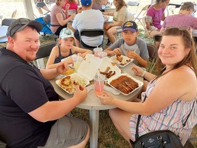 Mike Guyett, left, of Dealtown, is seen here enjoying some great food at Chatham-Kent Ribfest on in July with his daughter Addisyn, 9, son Keegan, 12, and wife Courtney.  The event is one of several which will need to relocate in 2023 due to construction around Tecumseh Park.  (Ellwood Shreve/Chatham Daily News)