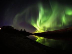 The Northern Lights shine and reflect on the Clearwater River in Fort McMurray Alta.  on Wednesday September 28, 2016. Robert Murray/Fort McMurray Today/Postmedia Network