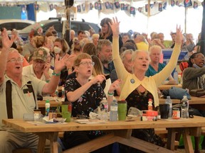 Ralph Dahl, Karen Dahl, and Vickie Hallman, right, sing along with Will Chalmers singing Sweet Caroline during Senior's Afternoon at the 34th Owen Sound Salmon Spectacular at Georgian Shores Marina in Owen Sound, Ontario  on Wednesday, August 31, 2022.