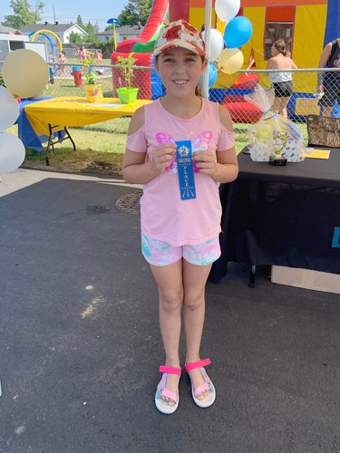 Leah McEwan proudly shows off her second place ribbon in the ages nine to 11 category of the LV Junior Gardeners Competition.
