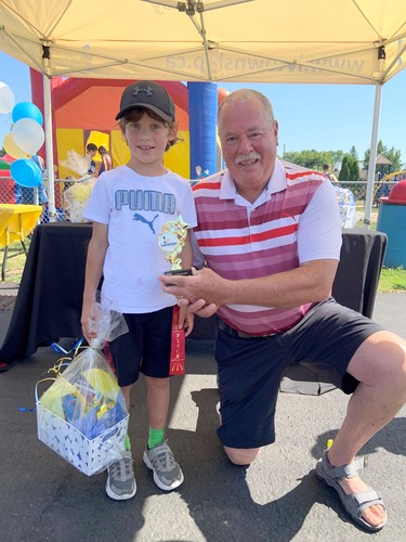 Mason Behm receives his first place prize package from Laurentian Valley Mayor Steve Bennett during the Junior Gardener awards presented during Stafford Party in the Park. Mason competed in the ages six to eight category.