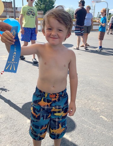 Second place winner in the ages one to five category of the Laurentian Valley Junior Gardeners Competition, Parker Adam, is all smiles as he receives his ribbon.