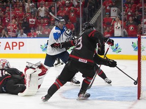 Canada's Mason McTavish (23) saves the puck from going into the net on a shot from Finland during overtime IIHF World Junior Hockey Championship gold medal game action in Edmonton on Saturday August 20, 2022. THE CANADIAN PRESS/Jason Franson