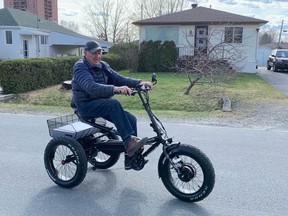 Joe Doucet test-drives an e-trike on the street outside his home in New Sudbury. The vehicle pictured here is not the one that was stolen.