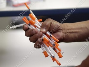 Used needles are shown at a needle exchange in Miami, May 6, 2019. Despite pandemic slow-downs, Correctional Service Canada is still planning to expand the needle exchange programs currently offered at nine federal prisons, government officials say. THE CANADIAN PRESS/AP/Lynne Sladky