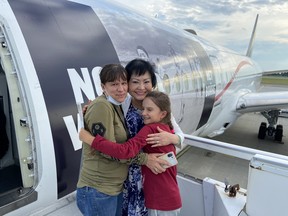 Kim Phuc Phan Thi poses with Ukrainians leaving Warsaw, Poland, for Canada in this recent handout photo. THE CANADIAN PRESS/HO - KIM Foundation International
