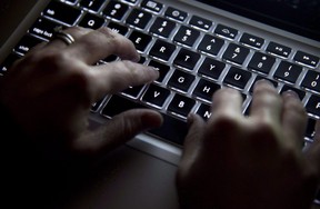 A woman uses her computer keyboard to type while surfing the internet in North Vancouver, B.C., on December 19, 2012. (THE CANADIAN PRESS/Jonathan Hayward)