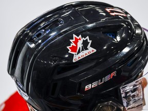 A Hockey Canada logo is visible on the helmet of a national junior team player during a training camp practice in Calgary, Tuesday, Aug. 2, 2022.THE CANADIAN PRESS/Jeff McIntosh