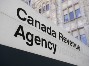 A sign outside the Canada Revenue Agency is seen Monday May 10, 2021 in Ottawa. The Canada Revenue Agency says it will be sending e-notifications about uncashed checks to 25,000 Canadians this month.THE CANADIAN PRESS/Adrian Wyld
