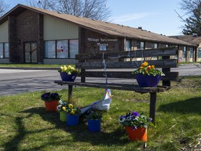 Flowers sit on a bench in front of Orchard Villa care home in Pickering, Ont. on Monday April 27, 2020. The province has introduced legislation that will allow hospital patients waiting for a bed in long-term care to be sent to a home without their consent.THE CANADIAN PRESS/Frank Gunn