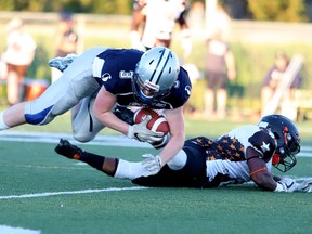 Zack Primeau of the Sudbury Spartans gets taken down by an unidentified GTA All-Stars player during NFC semi-final action  from James Jerome Field on Saturday evening. Gino Donato/For The Sudbury Star