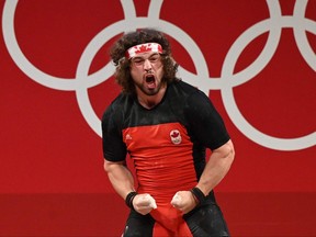 Canada's Boady Santavy reacts while competing in the men's 96-kg weightlifting competition during the Tokyo 2020 Olympic Games at the Tokyo International Forum in Tokyo on July 31, 2021. (Photo by LUIS ACOSTA/AFP via Getty Images)