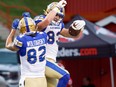 Winnipeg Blue Bombers' Dalton Schoen celebrates with Drew Wolitarsky after his touchdown against Calgary Stampeders on Saturday night. / POSTMEDIA