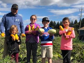 Dennis Stelmack poses with a group of youngsters who Grew Their Own vegetables. Photo/Facebook Grow Your Own Project.
