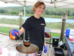An employee of the Canadian Brewhouse serves stew at the Empty Bowls fundraiser for the Wood Buffalo Food Bank. The annual fundraiser was held at the Fort McMurray Heritage Shipyard on Sunday, August 28, 2022. Vincent McDermott/Fort McMurray Today/Postmedia Network