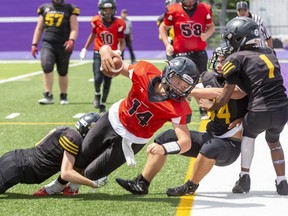 Brantford Bisons quarterback Peter Wright lunges into the end zone for a two-point conversion while being tackled by Cole Pretty of the Hamilton Jr. Tiger Cats during their Ontario Summer Football League U14 championship game Sunday at Western University's Alumni Stadium. Hamilton won the game, 52-45. (Derek Ruttan/The London Free Press)