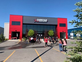 CARSTAR employees gave vehicles a pressure wash in the parking lot for the annual,"Soaps It Up," fundraiser, generating over $1,700 for Cystic Fibrosis Canada. Photo courtesy of CARSTAR.