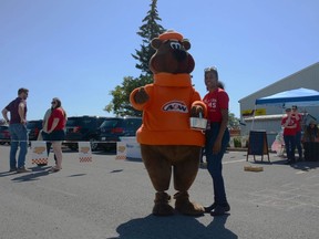 Shakeria Trotman stands with the Root Bear outside of the Edmonton Trail A&W, where the MS Society of Canada was present alongside games and facepainting for this year's Burgers to Beat MS. Photo by Riley Cassidy/The Airdrie Echo/Postmedia Network Inc.
