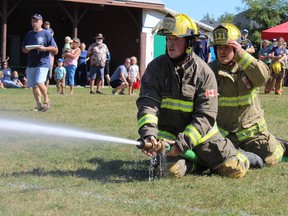 Local volunteer firefighters take aim in the pump competition on Saturday at Lions Park in Courtland. Volunteer firefighters competed in a number of events, including water barrel, bucket brigade and a truck pull, in a friendly contest involving local firefighters. Michelle Ruby